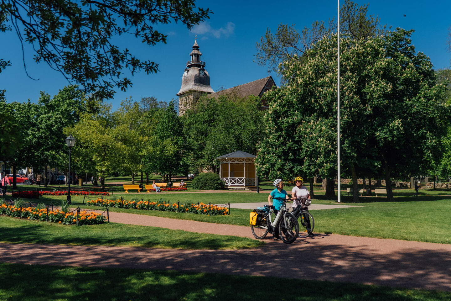 Cyclist walking through a park