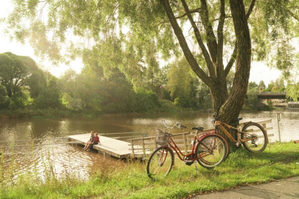 Ihmisiä laiturilla jalat vedessä